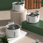 Three modern white automatic pet water fountains displayed together on tiered display pedestals.