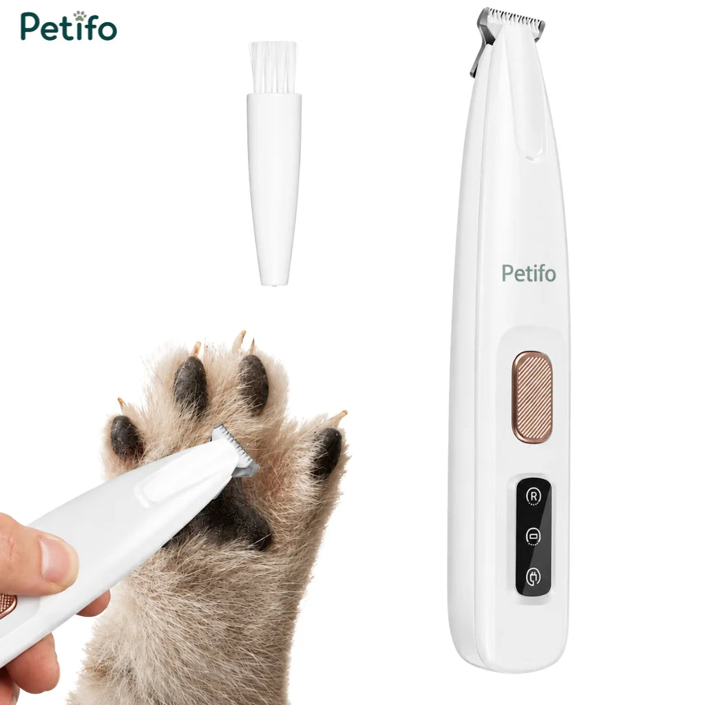A white pet paw trimmer shown beside a small cleaning brush while gently grooming a dog's furry paw.