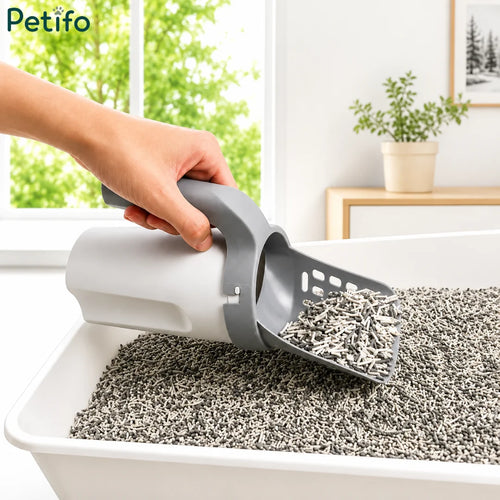Ergonomic grey cat litter scoop effortlessly filtering clean litter from a modern litter box.