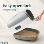 Person demonstrating the easy open lock mechanism of the grey and white hooded cat litter box for simpler daily cleaning.