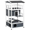 Multi-tier outdoor wooden cat house and climbing tower featuring grey and white panels.