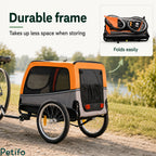 Grey and orange dog bike trailer shown fully assembled alongside a folded-up view demonstrating its space-saving storage design.